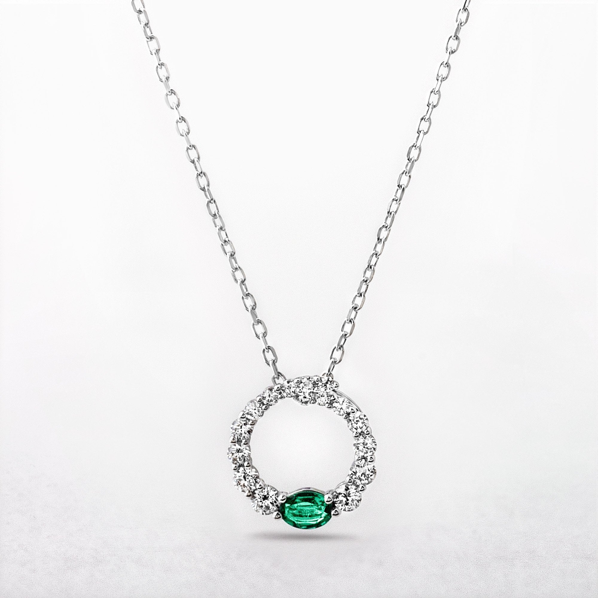 0.11ct Oval Cut Emerald and 0.31ct Diamond Set Pendant in 18ct White Gold