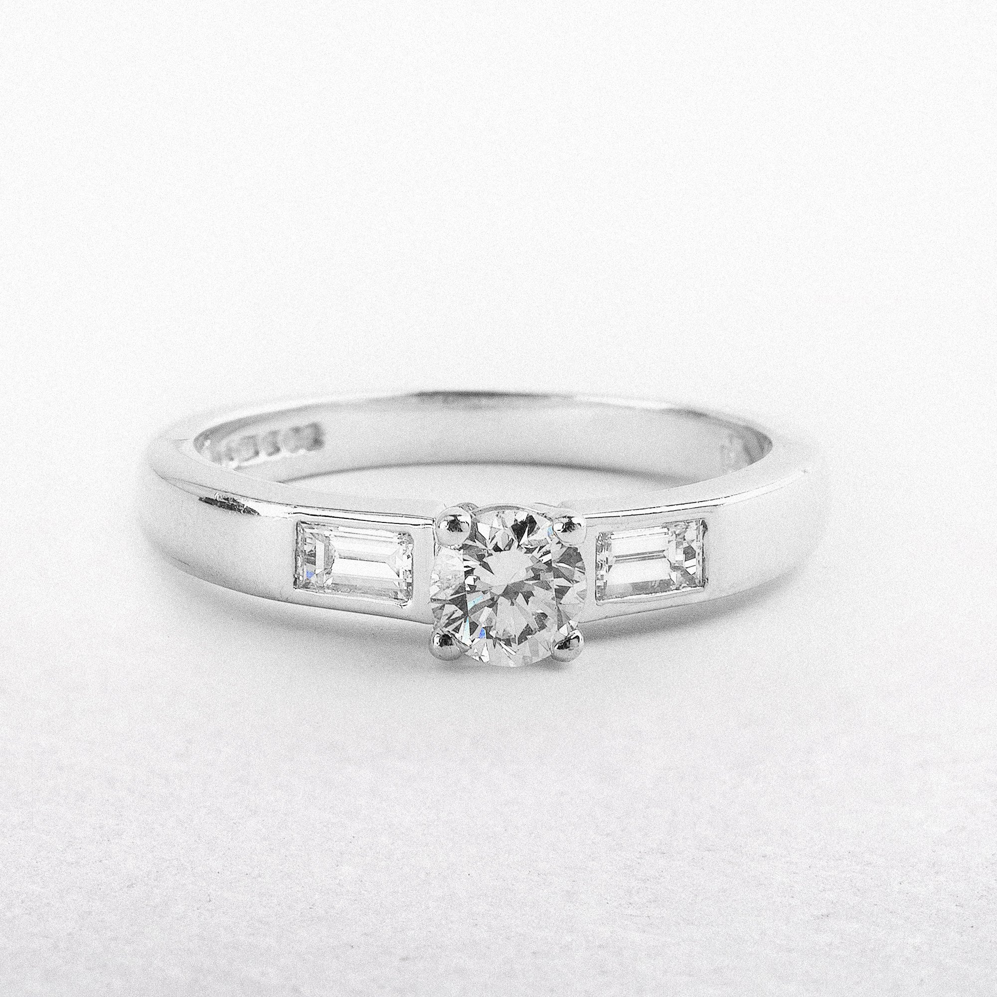 0.59ct Round Cut Natural Diamond Solitaire With Baguette Side Diamonds Set In 18ct White Gold