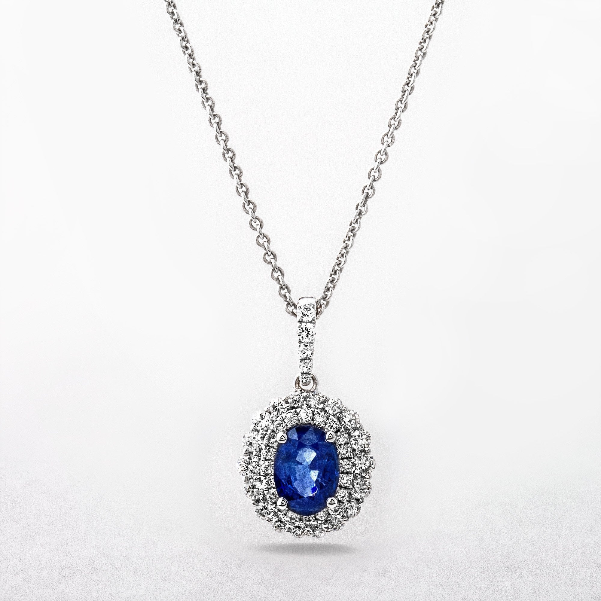 0.87ct Sapphire and 0.42ct Diamond Oval Halo Pendant in 18ct White Gold