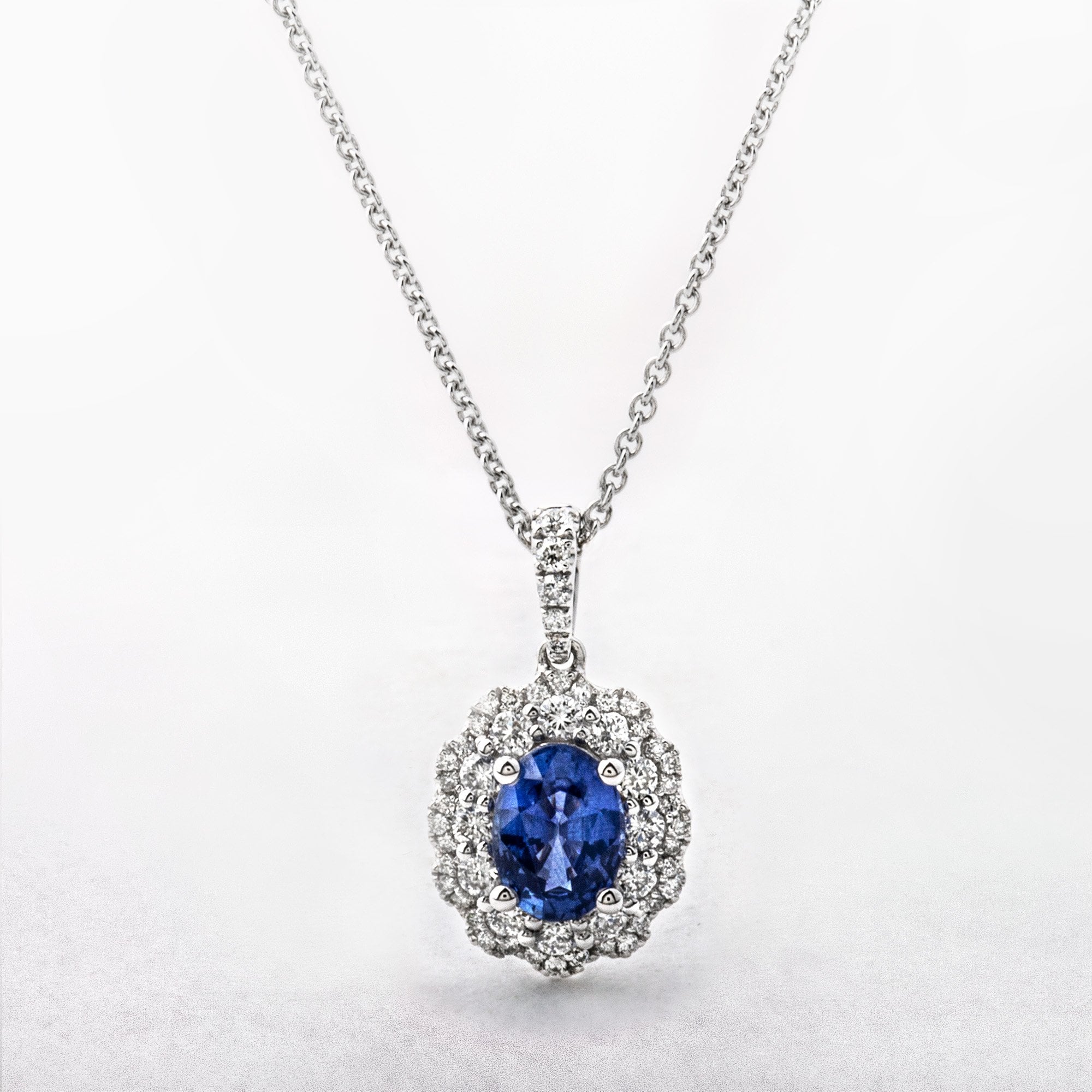 1.02ct Oval Cut Sapphire and 0.40ct Diamond Pendant in 18ct White Gold
