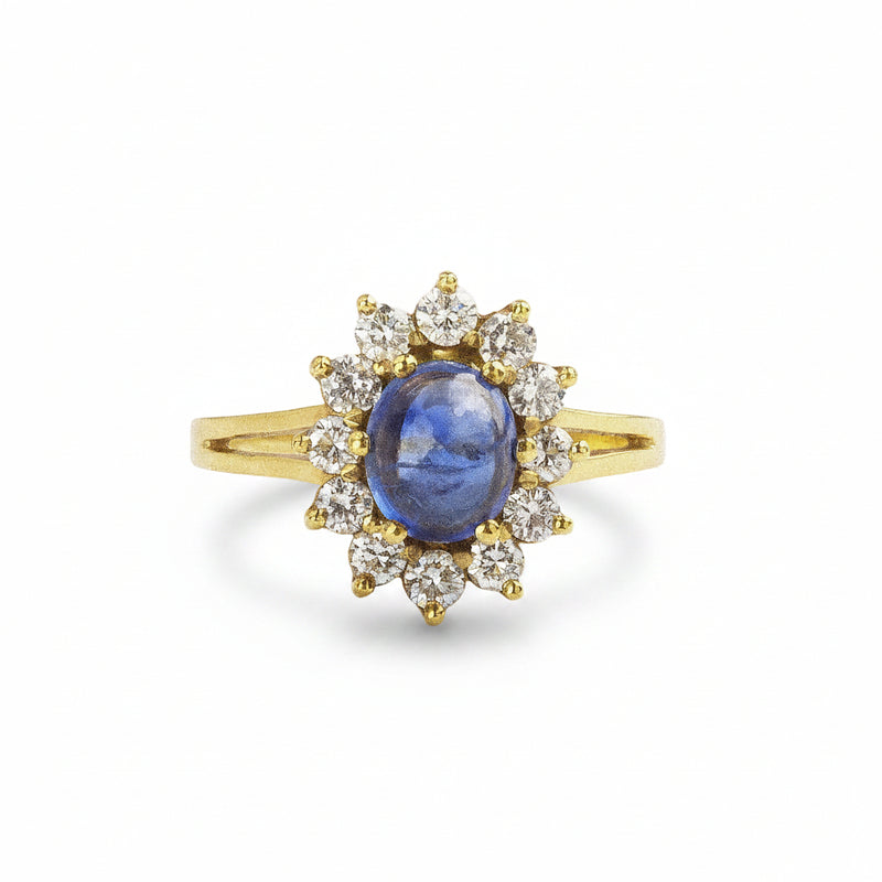 18ct yellow gold oval Cabochon sapphaire 1.31ct, diamond halo 0.57ct ring