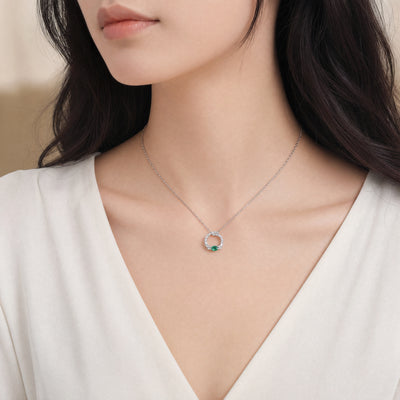 0.11ct Oval Cut Emerald and 0.31ct Diamond Set Pendant in 18ct White Gold