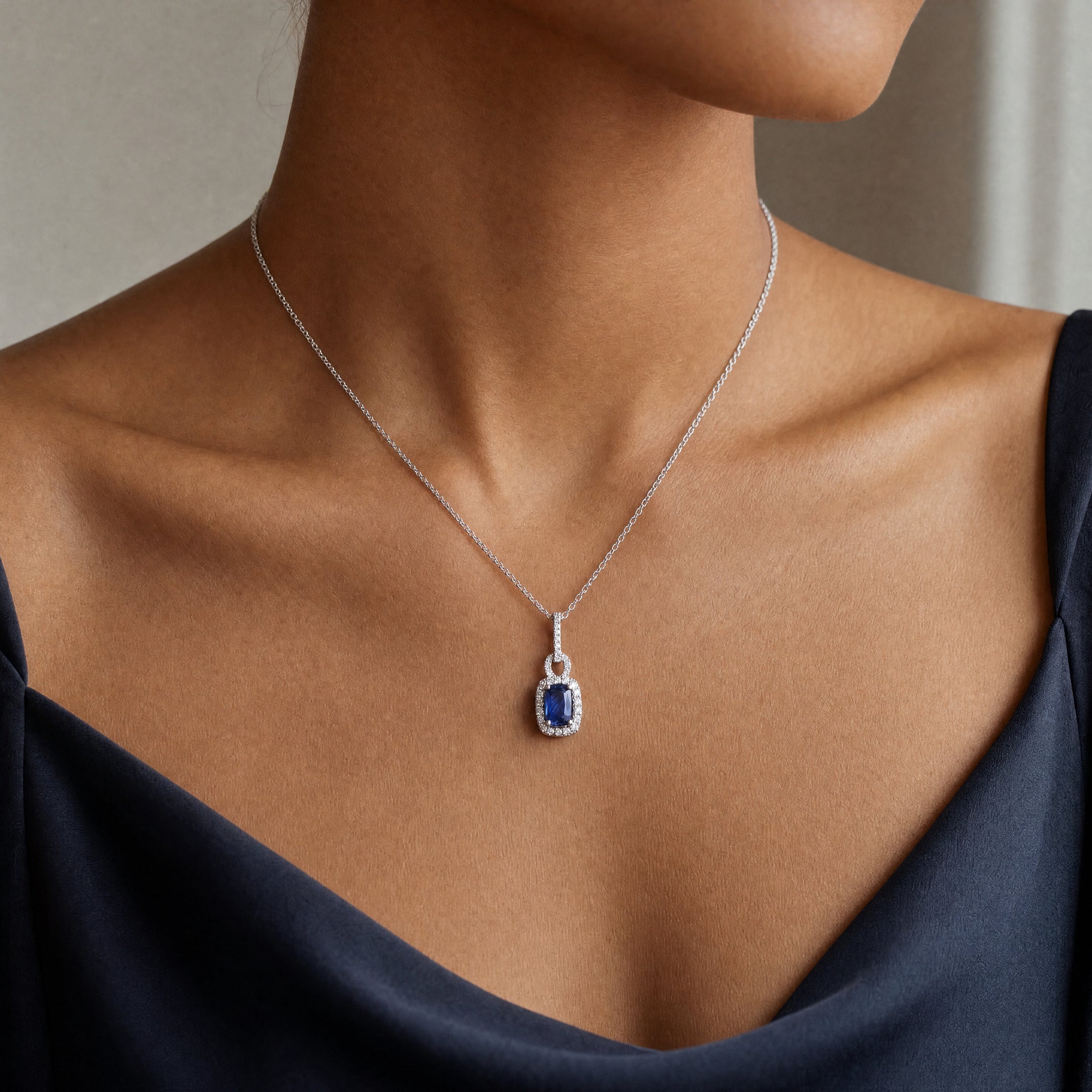 1.04ct Sapphire and 0.30ct Diamond Rectangular Halo Pendant in 18ct White Gold