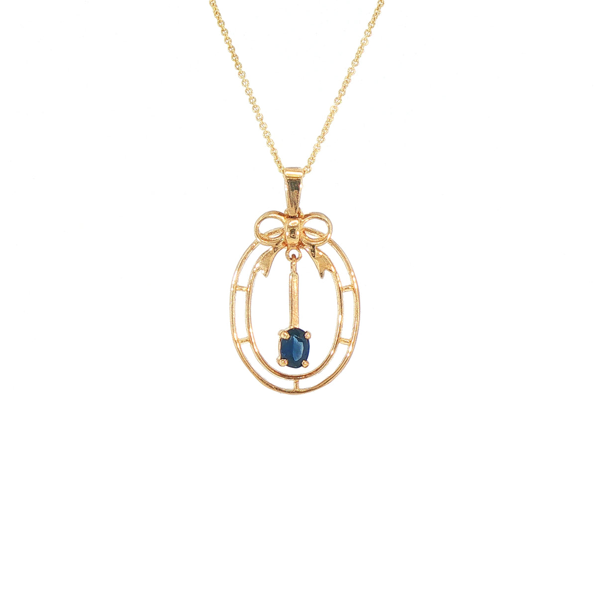 Vintage-Inspired Bow Pendant with Royal Blue Sapphire Set in 9ct Gold