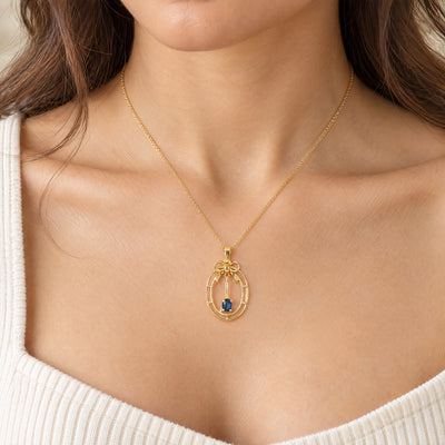 Vintage-Inspired Bow Pendant with Royal Blue Sapphire Set in 9ct Gold