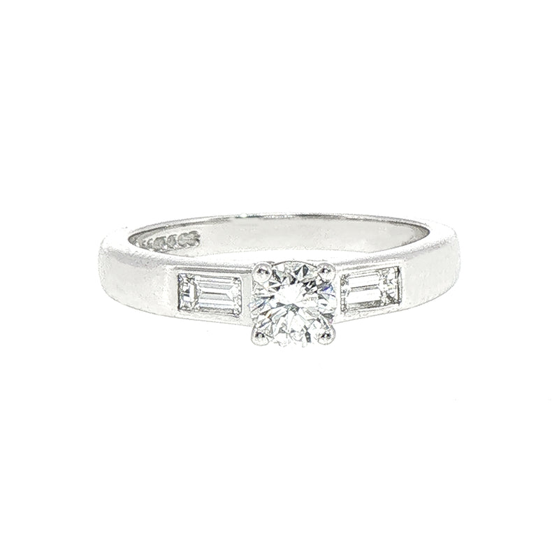 0.59ct Round Cut Natural Diamond Solitaire With Baguette Side Diamonds Set In 18ct White Gold