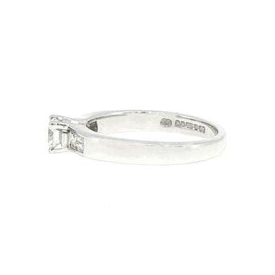0.59ct Round Cut Natural Diamond Solitaire With Baguette Side Diamonds Set In 18ct White Gold