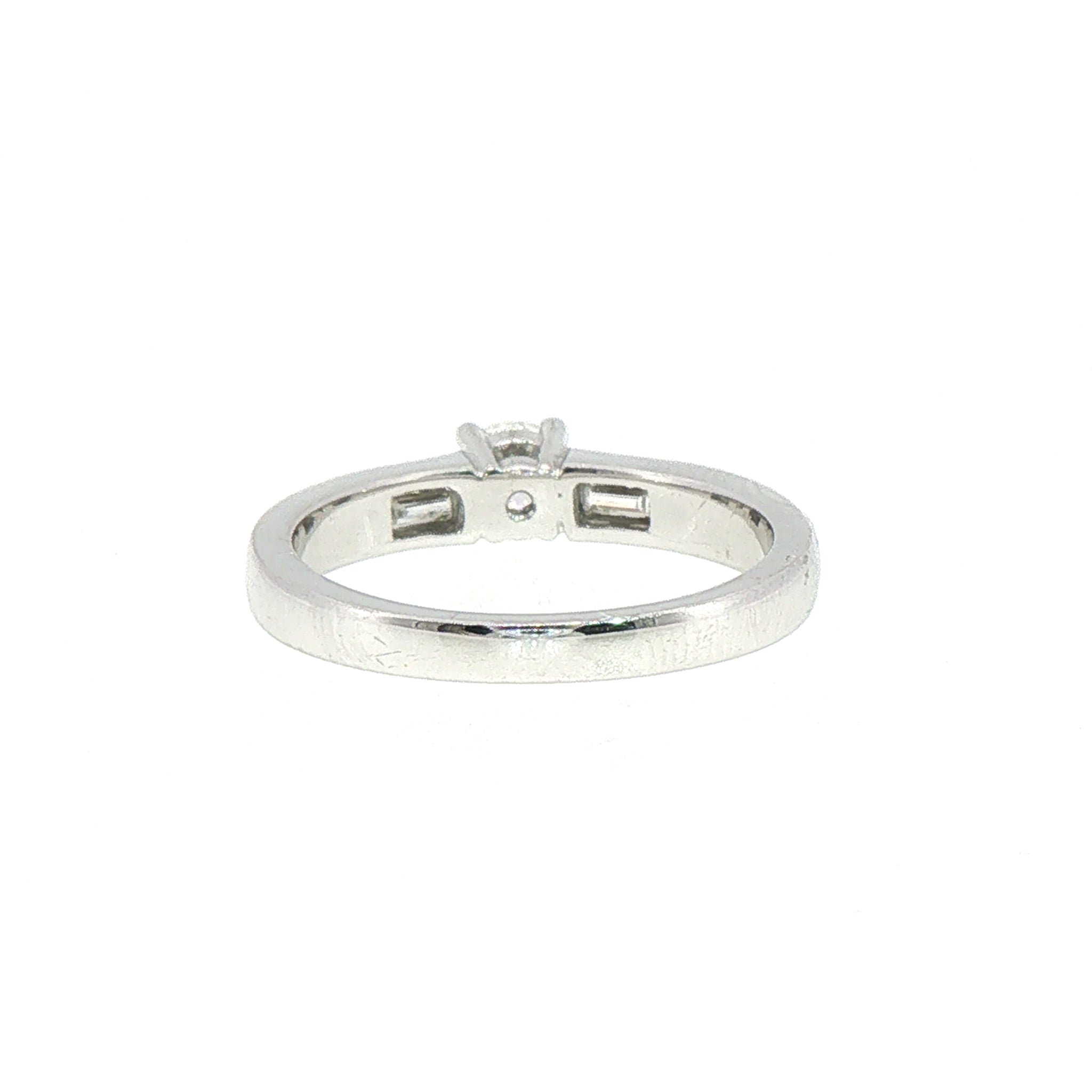 0.59ct Round Cut Natural Diamond Solitaire With Baguette Side Diamonds Set In 18ct White Gold