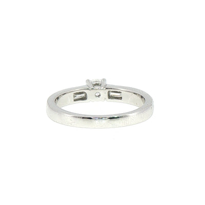 0.59ct Round Cut Natural Diamond Solitaire With Baguette Side Diamonds Set In 18ct White Gold