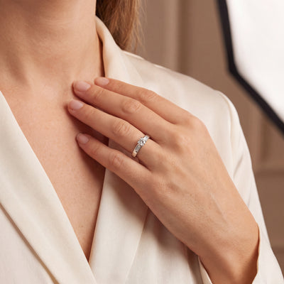0.59ct Round Cut Natural Diamond Solitaire With Baguette Side Diamonds Set In 18ct White Gold