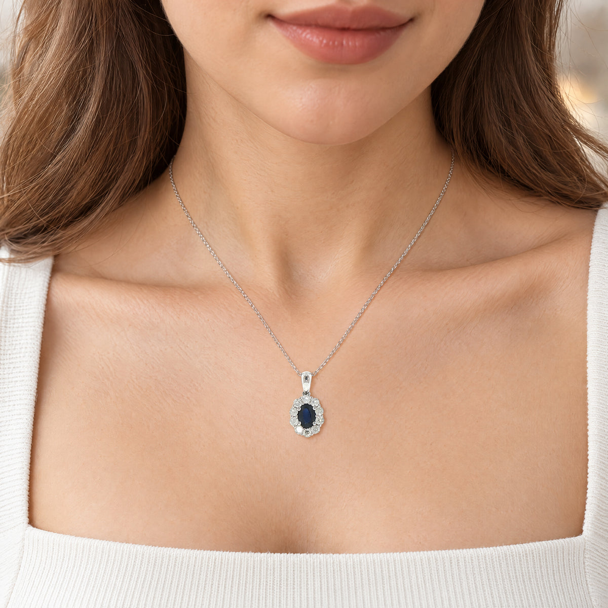 Oval Sapphire and Natural Diamond Cluster Pendant in 18ct White Gold